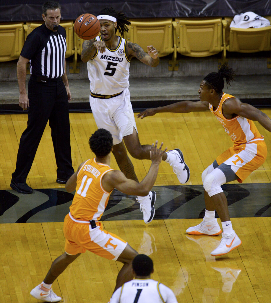 University of Missouri forward Mitchell Smith, center, passes the ball past the Tennessee defense to teammate Xavier Pinson